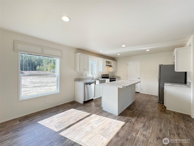 303 Critter Country Trl, Sequim, WA 98382 - kitchen featuring appliances with stainless steel finishes, a center island, white cabinets, light countertops, and dark wood finished floors