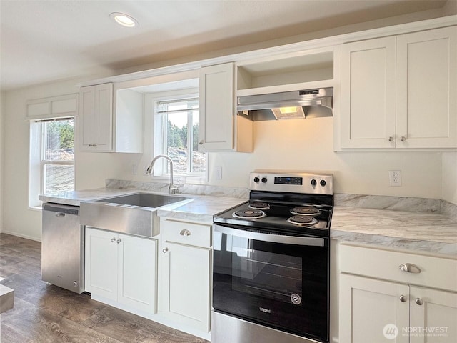 303 Critter Country Trl, Sequim, WA 98382 - kitchen featuring appliances with stainless steel finishes, wall chimney range hood, plenty of natural light, light countertops, and recessed lighting