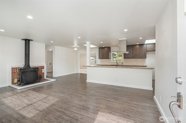 16812 125th Ave SE, Renton, WA 98058 - unfurnished living room featuring wood finished floors, recessed lighting, and a wood stove