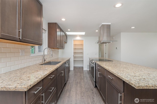 16812 125th Ave SE, Renton, WA 98058 - kitchen with island exhaust hood, stainless steel appliances, light wood-style flooring, backsplash, and dark brown cabinetry