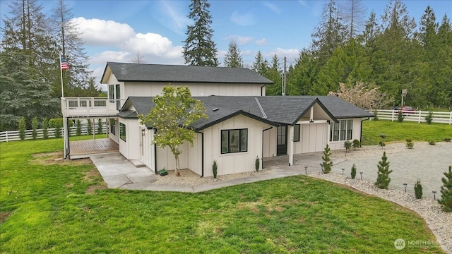 150 Cliff Robinson Ln, Sequim, WA 98382 - rear view of property featuring board and batten siding, a shingled roof, a patio area, and a wooden deck