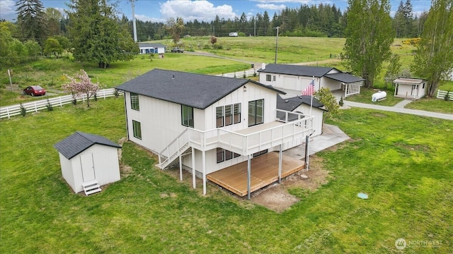 150 Cliff Robinson Ln, Sequim, WA 98382 - back of property with a shed, roof with shingles, and a wooden deck