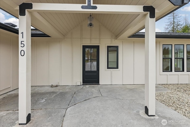 150 Cliff Robinson Ln, Sequim, WA 98382 - view of exterior entry with board and batten siding and a patio area
