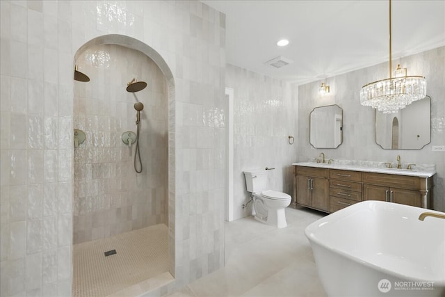 150 Cliff Robinson Ln, Sequim, WA 98382 - full bathroom featuring a walk in shower, double vanity, tile patterned flooring, tile walls, and a freestanding tub