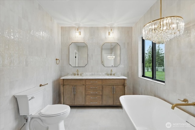150 Cliff Robinson Ln, Sequim, WA 98382 - full bath featuring tile walls, a freestanding bath, double vanity, tile patterned floors, and a chandelier