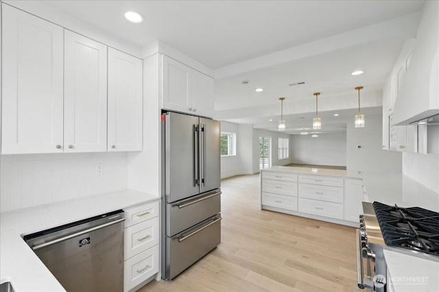 150 Cliff Robinson Ln, Sequim, WA 98382 - kitchen featuring stainless steel appliances, custom exhaust hood, recessed lighting, light wood finished floors, and light countertops