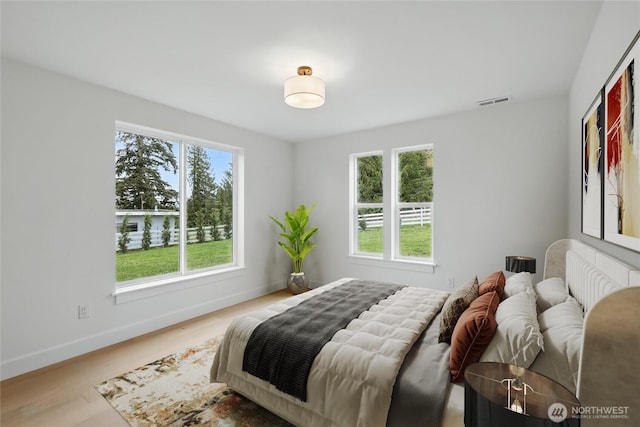 150 Cliff Robinson Ln, Sequim, WA 98382 - bedroom featuring multiple windows and wood finished floors
