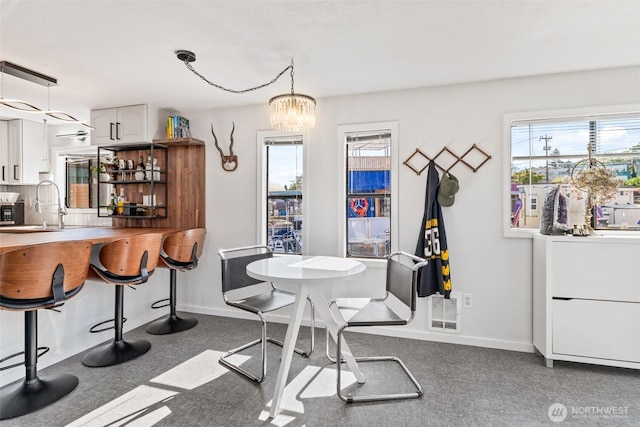 2401 N Northlake Way Unit F6, Seattle, WA 98103 - dining space with a chandelier and baseboards