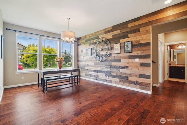 13712 Big Sky Dr E, Bonney Lake, WA 98391 - dining area with wood walls, wood finished floors, a chandelier, and an accent wall