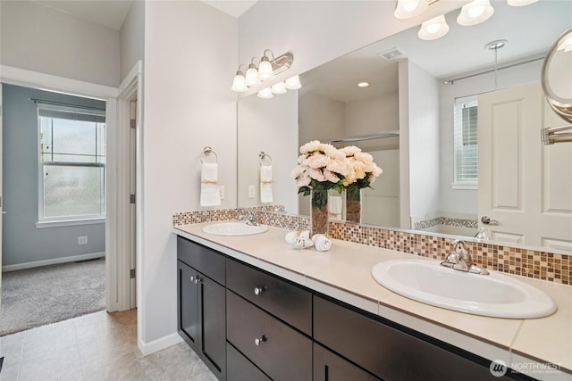 13712 Big Sky Dr E, Bonney Lake, WA 98391 - bathroom featuring double vanity, tasteful backsplash, and a shower