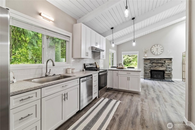 1535 Ten Mile Rd, Everson, WA 98247 - kitchen featuring stainless steel appliances, backsplash, a wooden ceiling with exposed beams, a peninsula, and healthy amount of natural light