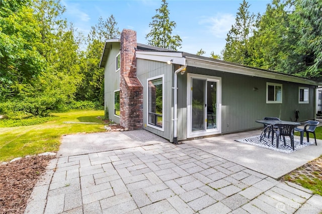 1535 Ten Mile Rd, Everson, WA 98247 - back of property featuring a patio, a chimney, and a lawn