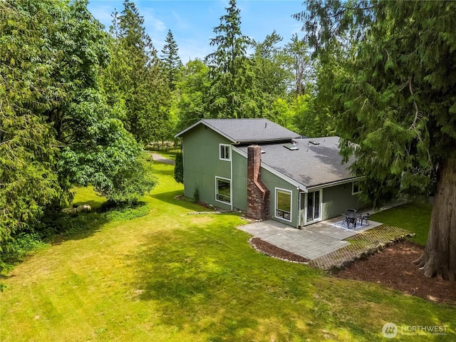 1535 Ten Mile Rd, Everson, WA 98247 - back of property featuring a patio, a lawn, and roof with shingles