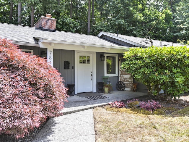7819 25th Ave E, Tacoma, WA 98404 - doorway to property with a chimney and a shingled roof
