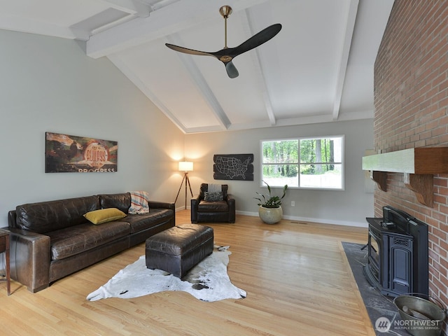 7819 25th Ave E, Tacoma, WA 98404 - living area with ceiling fan, wood finished floors, and a wood stove