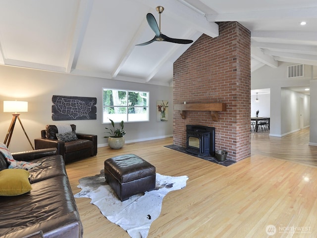 7819 25th Ave E, Tacoma, WA 98404 - living room with wood finished floors, ceiling fan, and a wood stove
