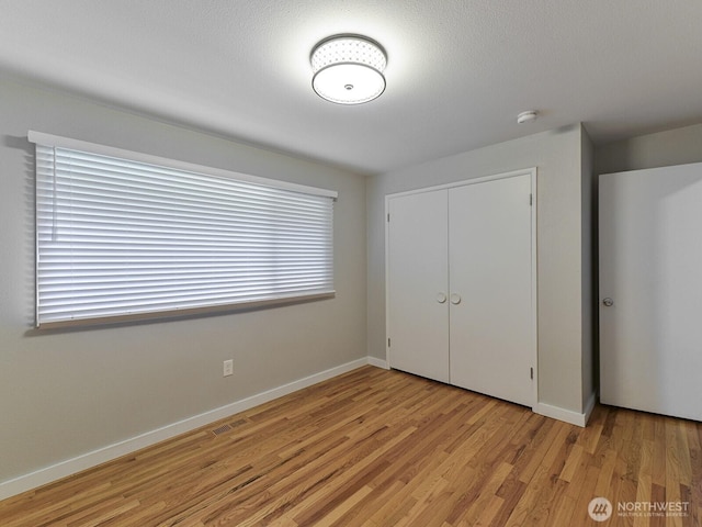 7819 25th Ave E, Tacoma, WA 98404 - unfurnished bedroom featuring a closet and light wood finished floors