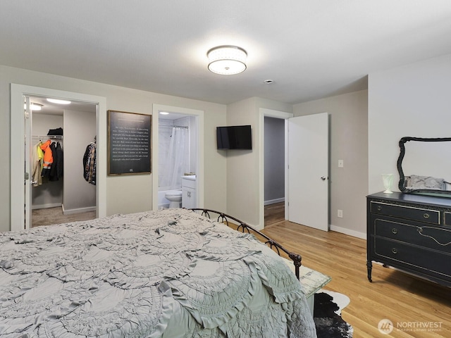 7819 25th Ave E, Tacoma, WA 98404 - bedroom with a walk in closet, light wood-style flooring, ensuite bath, and a closet