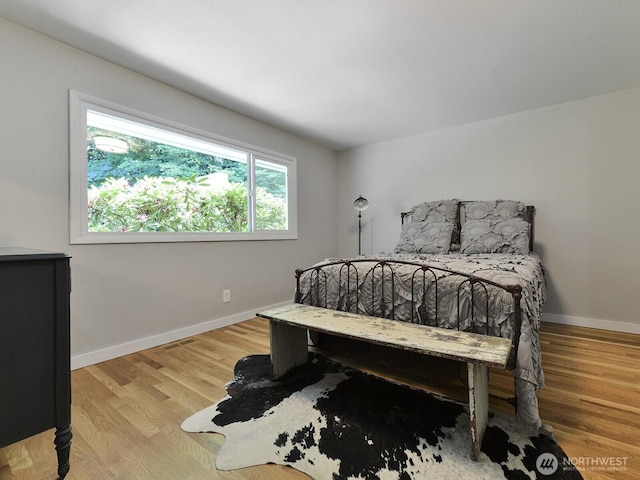 7819 25th Ave E, Tacoma, WA 98404 - bedroom featuring baseboards and light wood finished floors