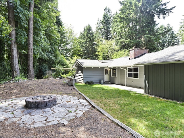 7819 25th Ave E, Tacoma, WA 98404 - view of grassy yard featuring a fire pit and a patio