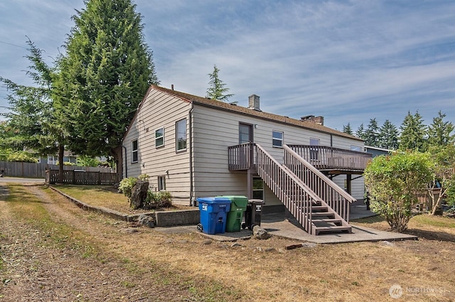 5312 S Hazel St, Seattle, WA 98178 - rear view of house with a chimney, a wooden deck, and stairs