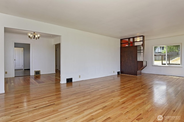 5312 S Hazel St, Seattle, WA 98178 - unfurnished living room with a chandelier and wood finished floors