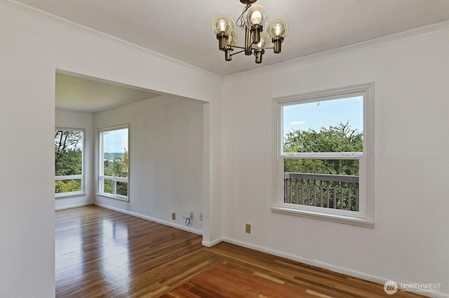 5312 S Hazel St, Seattle, WA 98178 - unfurnished dining area with healthy amount of natural light, wood finished floors, a chandelier, and ornamental molding