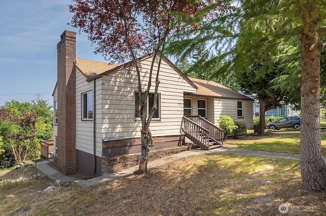 5312 S Hazel St, Seattle, WA 98178 - view of front of home with a chimney, a front yard, and roof with shingles