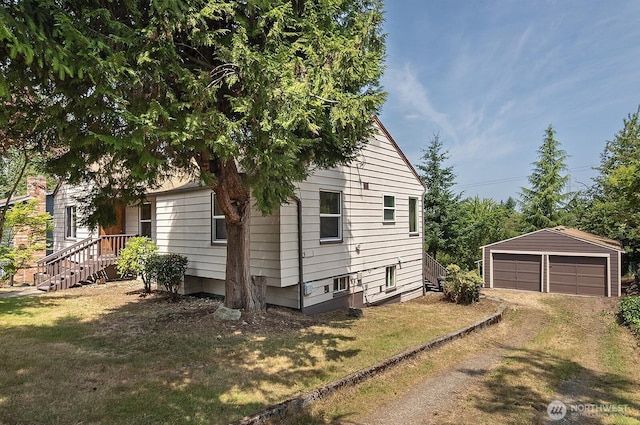 5312 S Hazel St, Seattle, WA 98178 - view of home's exterior featuring a garage, an outbuilding, and a lawn