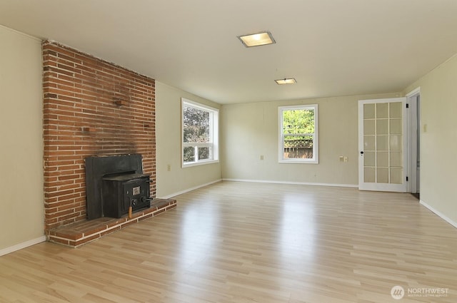 5312 S Hazel St, Seattle, WA 98178 - unfurnished living room featuring light wood finished floors and a wood stove