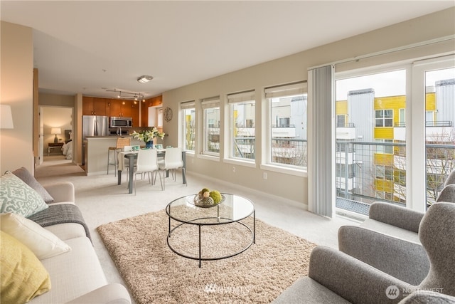 2440 Western Ave Unit 503, Seattle, WA 98121 - living area with light colored carpet and rail lighting