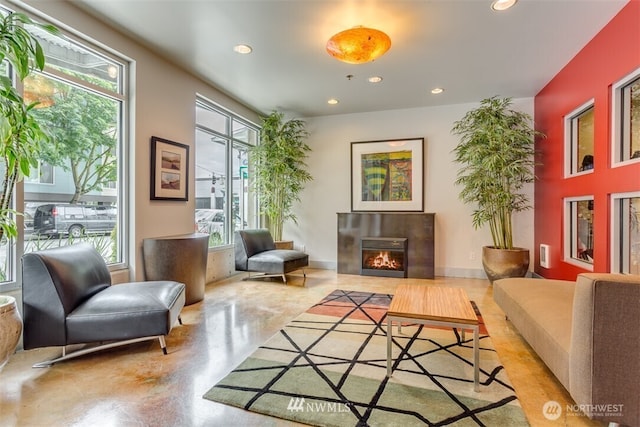 2440 Western Ave Unit 503, Seattle, WA 98121 - sitting room featuring a glass covered fireplace, recessed lighting, and concrete floors