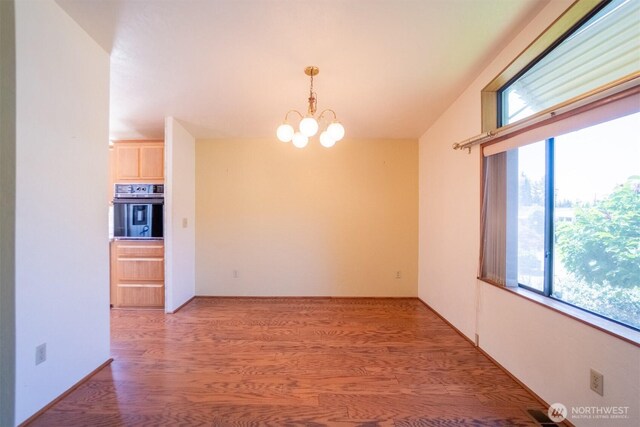 37301 28th Ave S Unit 4, Federal Way, WA 98003 - empty room with light wood finished floors, a chandelier, and plenty of natural light