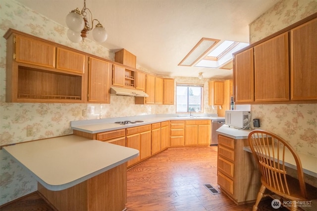 37301 28th Ave S Unit 4, Federal Way, WA 98003 - kitchen featuring under cabinet range hood, wallpapered walls, white appliances, light wood-style flooring, and a skylight
