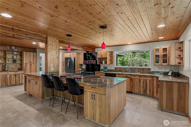 359 Timber Ridge Canyon Rd, Leavenworth, WA 98826 - kitchen featuring open shelves, freestanding refrigerator, recessed lighting, dark stone counters, and a kitchen breakfast bar