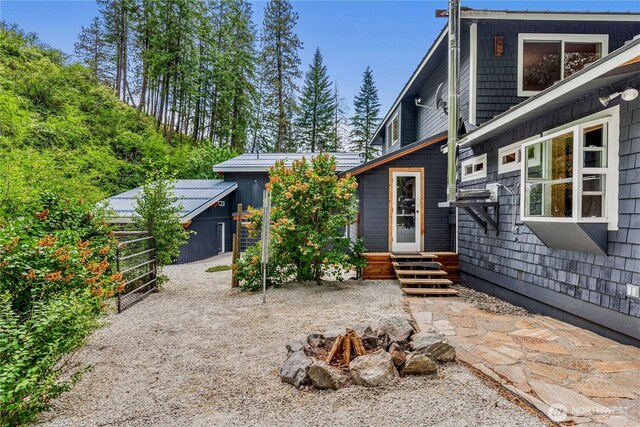 359 Timber Ridge Canyon Rd, Leavenworth, WA 98826 - rear view of property featuring a fire pit