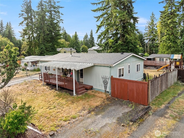 6211 203rd Street Ct E, Spanaway, WA 98387 - view of front of house with a deck, roof with shingles, and driveway