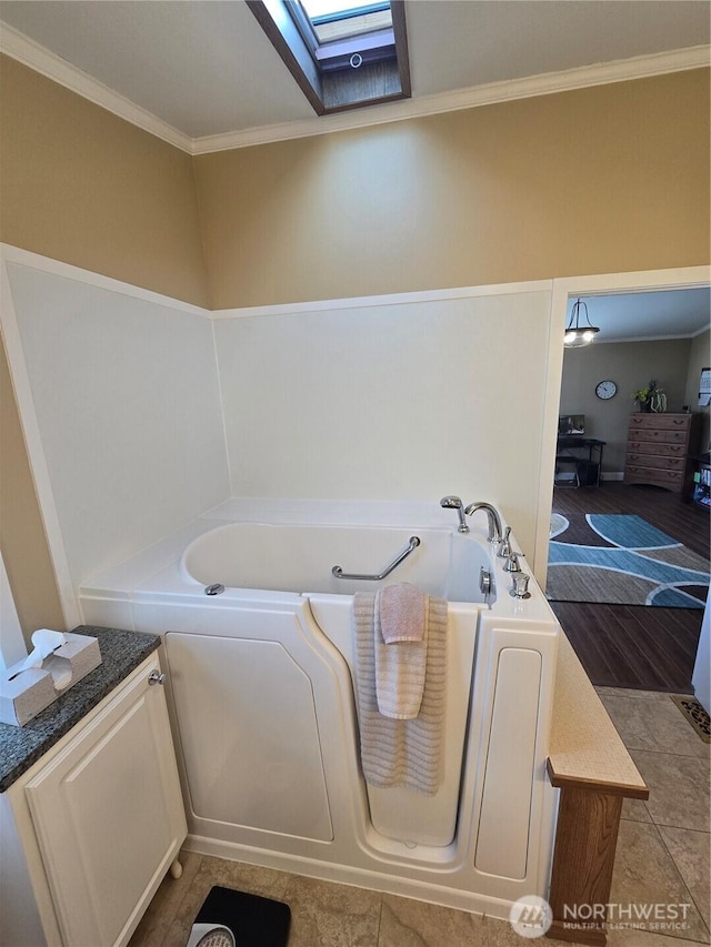 836 E Harman Way E Unit 62, Orting, WA 98360 - bathroom featuring a bath, crown molding, and a skylight