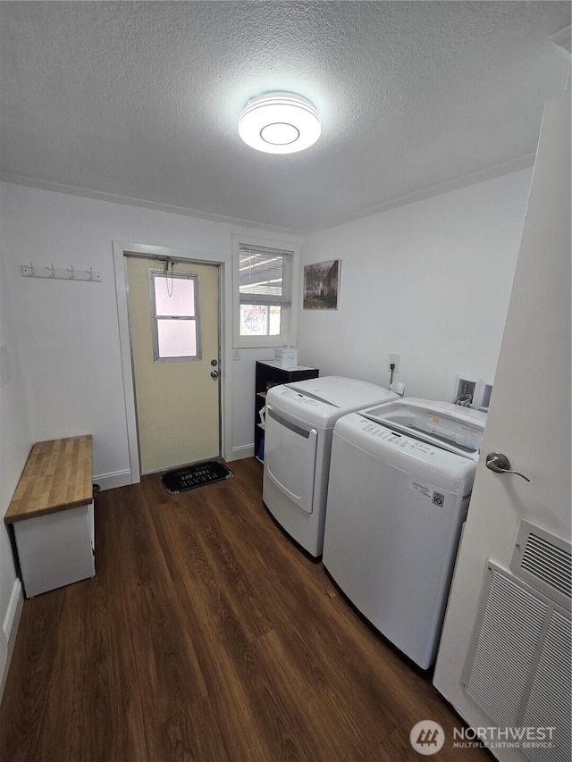 836 E Harman Way E Unit 62, Orting, WA 98360 - laundry room featuring washing machine and dryer, a textured ceiling, and dark wood-style floors