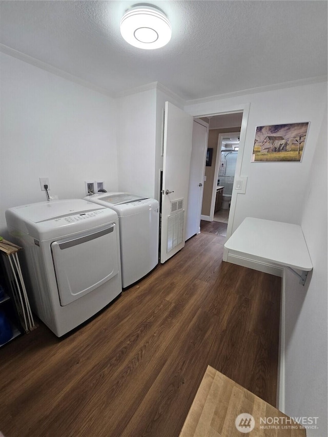 836 E Harman Way E Unit 62, Orting, WA 98360 - washroom featuring washer and clothes dryer, dark wood-style flooring, and a textured ceiling