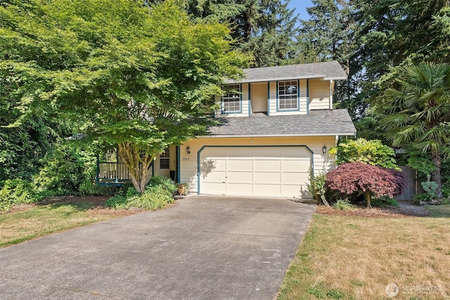 2735 Fordham Ct SE, Lacey, WA 98503 - view of front facade with concrete driveway, an attached garage, a shingled roof, and a front lawn