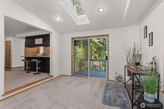 2735 Fordham Ct SE, Lacey, WA 98503 - doorway to outside with a skylight, carpet floors, vaulted ceiling, and recessed lighting