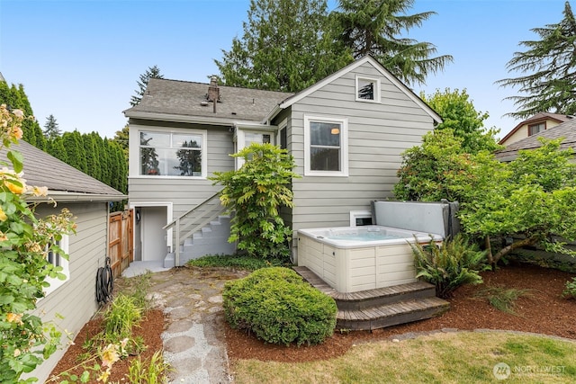 1230 NE 100th St, Seattle, WA 98125 - back of house featuring a hot tub, stairs, and roof with shingles