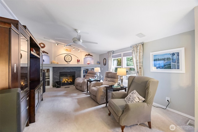 121 E Willapa Rd, Shelton, WA 98584 - living room with light carpet, a glass covered fireplace, and a ceiling fan