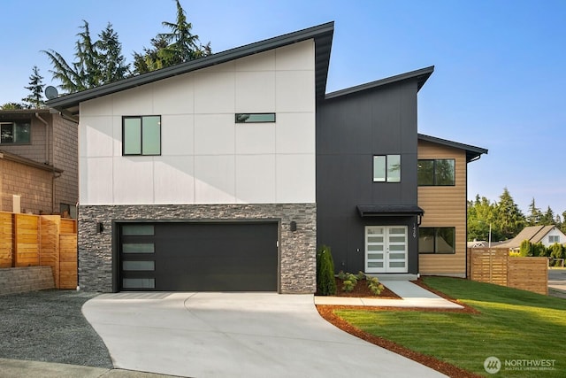 1429 S 259th St, Des Moines, WA 98198 - contemporary home with concrete driveway, stone siding, and an attached garage