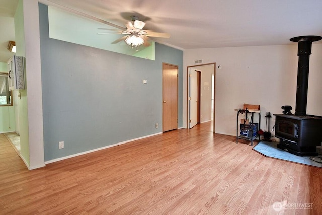 140 Fleming Dr, Sequim, WA 98382 - living room featuring ceiling fan, light wood-type flooring, and a wood stove