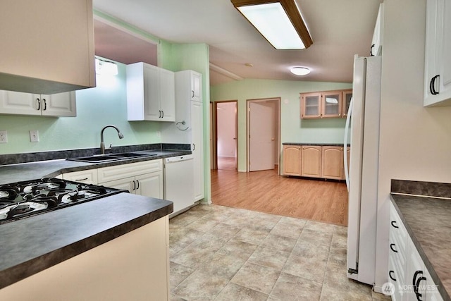 140 Fleming Dr, Sequim, WA 98382 - kitchen with white appliances, dark countertops, lofted ceiling, and white cabinets