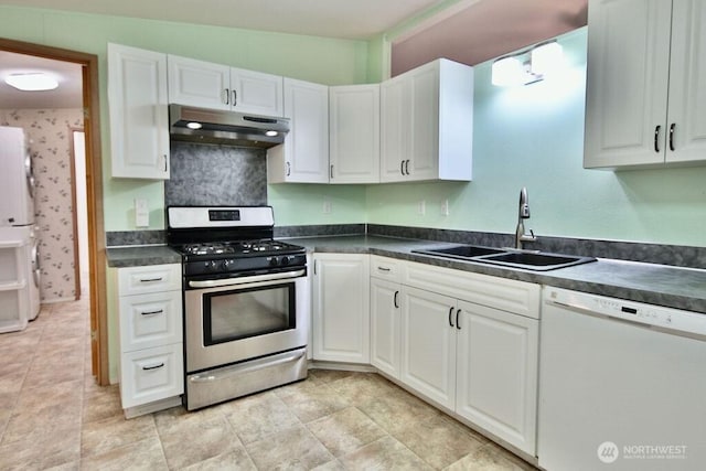 140 Fleming Dr, Sequim, WA 98382 - kitchen featuring white appliances, under cabinet range hood, dark countertops, and white cabinetry