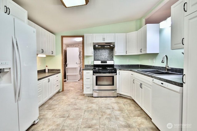 140 Fleming Dr, Sequim, WA 98382 - kitchen with white appliances, lofted ceiling, under cabinet range hood, dark countertops, and white cabinetry