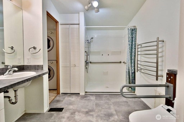 140 Fleming Dr, Sequim, WA 98382 - full bath featuring a closet, a shower stall, and stacked washer / dryer